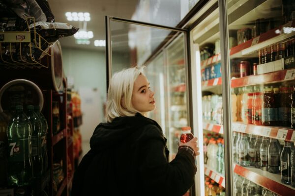 woman buying a drink at grocery store