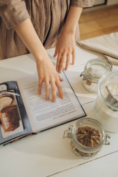 a woman reading a cookbook